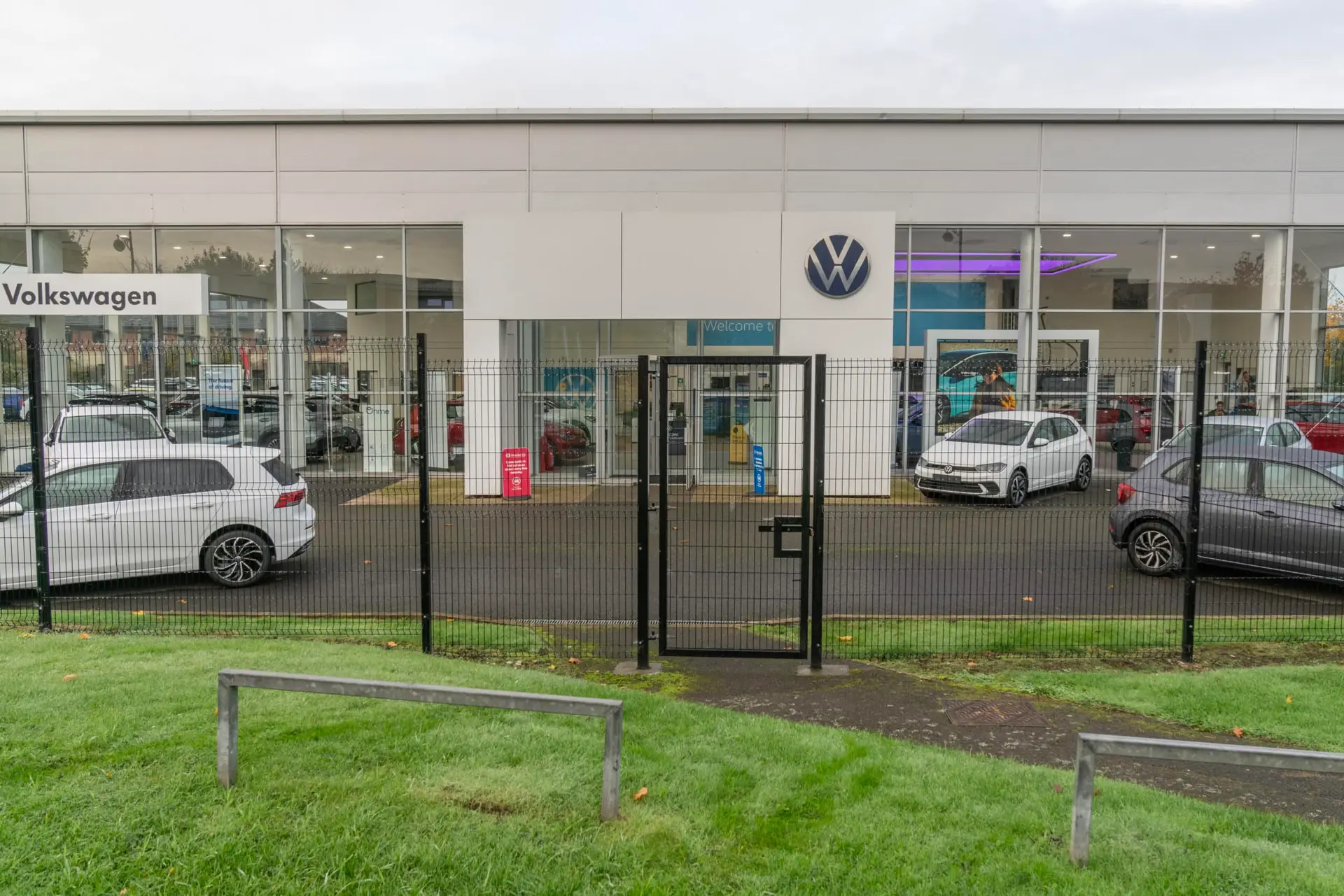 Black security gate with lock installed for VW car dealership by Direct Fencing & Contracting