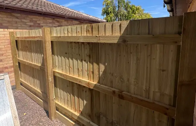 Fencing Services featuring professionally installed wooden feather edge privacy fencing along a residential garden boundary.