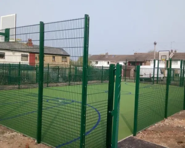 Sports Ground Fencing featuring green twin-wire mesh enclosure surrounding an outdoor multi-use games area court.